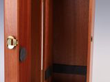 an open wooden box with a door on the inside