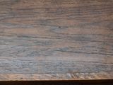 a brown wooden table with a white plate on top of it