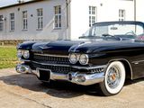 a black classic car parked in front of a building
