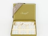 a green box with four candles and a ribbon in it