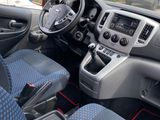 the interior of a small van with blue seats and a steering wheel