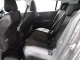 the back seats of a small car are black and grey