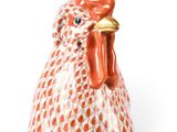 a figurine of a rooster on a white background