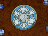 a wooden plate with a blue and white design on it