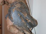 a wooden statue of a person hanging from a wall
