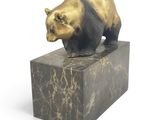 a statue of a bear on top of a marble block