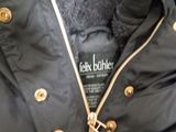 the jacket is black and has gold buttons on the collar