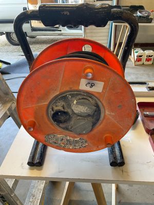 an orange hose sitting on top of a wooden table