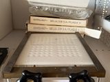 a stack of books sitting on top of a clear box