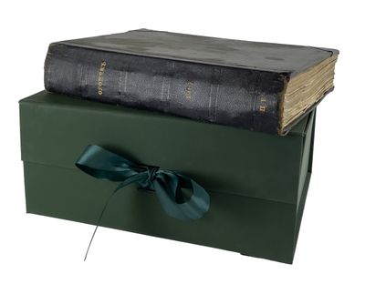 two books stacked on top of each other with a bow