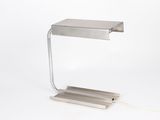 silver metal table lamp with a white cord on a white background