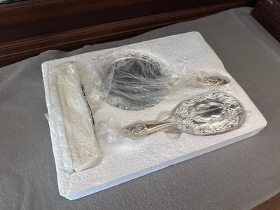 a white tray with silver items on it on a table