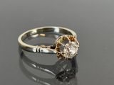 a close up of a diamond ring on a black surface