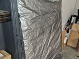 many boxes and boxes in a room with a silver cover