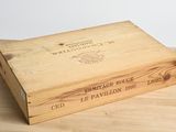 wooden box on a table with a wine label on it