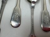 several spoons and spoon spoons are lined up on a table