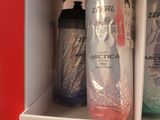 bottles of hand sanitizer are on a shelf in a bathroom