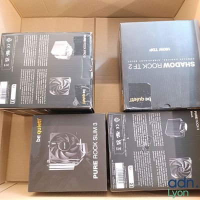 several boxes of computer equipment sitting on top of a cardboard box