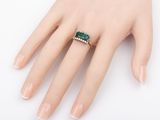 a close up of a person ' s hand with a ring on it