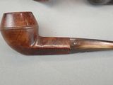 a pipe that is sitting on a table next to another pipe