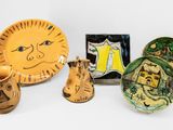 a lot of pottery items sitting on a white surface