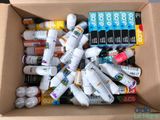 a cardboard box filled with various types of toothpaste