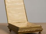 a gold box sitting on top of a wooden table
