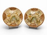 pair of gold plate with birds and flowers on them