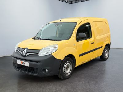 the small yellow van is parked in a large room