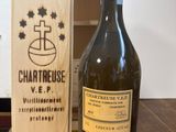 bottles of wine are sitting on a table next to a wooden box