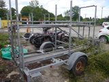 a trailer with a motorcycle attached to it in a parking lot