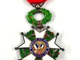 a close up of a medal on a white background with a red ribbon