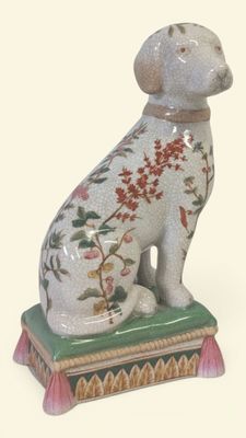 a figurine of a dog sitting on top of a box