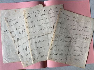 two old letters are on top of a piece of paper