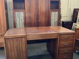 an image of a wooden desk with drawers and cabinets