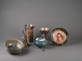 many different types of vases and bowls on the table