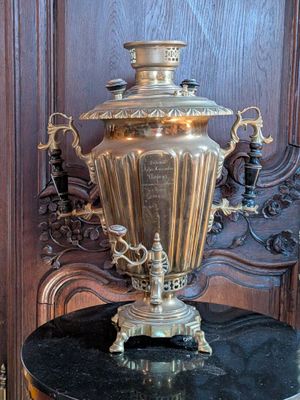 a large brass urn sitting on top of a table