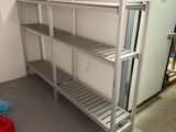 a metal shelf in the middle of a room