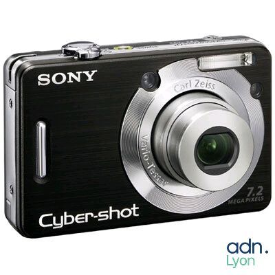 a black camera that is sitting on a white surface