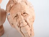 a clay head of a man and a bust of a woman