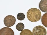 a lot of old coins that are on the table