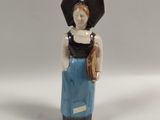 a figurine of a woman in a blue dress