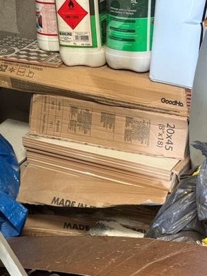 une pile de cartons et de bouteilles de produits chimiques posée sur une table