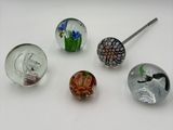 several different glass beads are arranged on a white surface