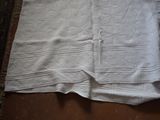 a white towel sitting on top of a wooden floor