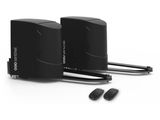 a couple of black speakers sitting next to each other on a white surface