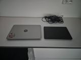 two laptops that are sitting on a white table