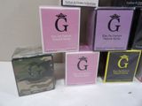 five boxes of perfume sitting on a table with a crown on top of them