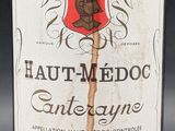 an old bottle of wine sitting on top of a table