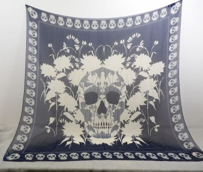 a blanket with a skull and flowers on it